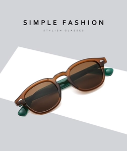 Detail view of vintage round tortoiseshell sunglasses with brown lenses at a 45-degree angle