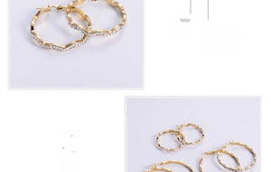 Detail of 18K gold-plated wavy hoop earrings with micro-pave white rhinestones set