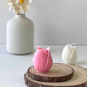 Elegant pink and white tulip scented candles on rustic wooden base for home decor
