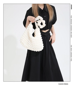 Close-up of white bubble textured tote bag and matching scrunchie set for women