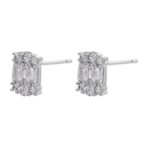 Macro shot of silver geometric earrings with rectangular zircons and 18K gold plated finish