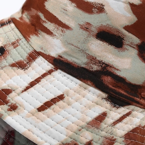Detailed view of tie-dye bucket hat stitching and high-quality cotton twill texture