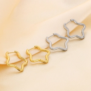 Minimalist stainless steel star-shaped hoop earrings in gold and silver on silk background