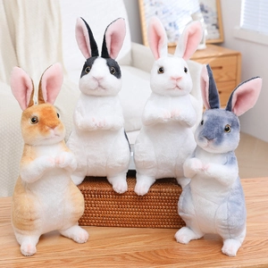 Realistic sitting bunny plush dolls in four colors shown in a cozy home setting