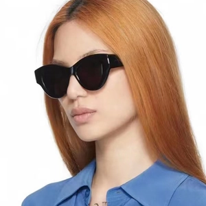 Women's vintage cat-eye sunglasses with oversized black frames and UV protection