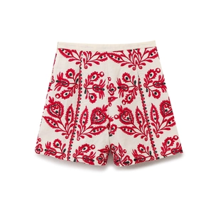 Short taille haute crème avec broderie florale bohème rouge présenté à plat sur blanc