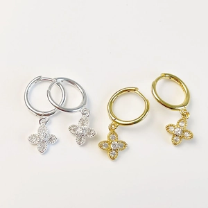 Detailed close-up of gold and silver S925 sterling silver clover earrings with zircons