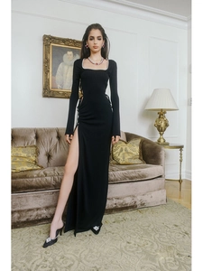 Detail of elegant black square neck dress featuring waist cut-out and high side slit design