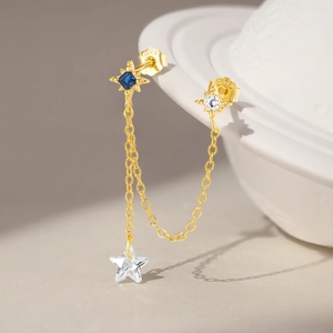 Detailed close-up of S925 sterling silver gold star and moon chain earrings with blue gems