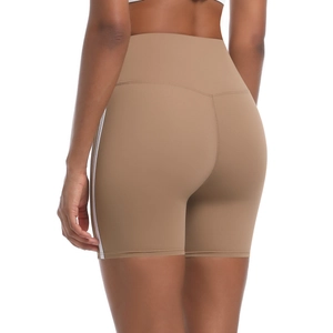Detail of high-waisted camel biker shorts with double side stripes and butt-lifting design