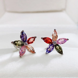 Macro shot of colorful floral earrings with five teardrop-shaped gemstones and claw setting