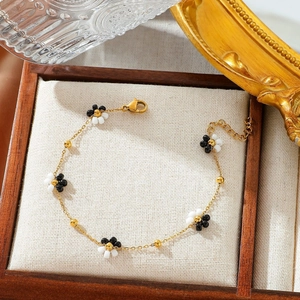 Minimalist 18K gold-plated beaded flower bracelet in a luxury wooden jewelry display box