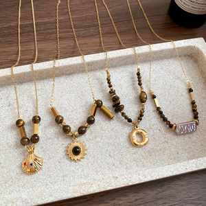 Retro tiger eye flower pendant necklace set with gold beads and shell charms on tray