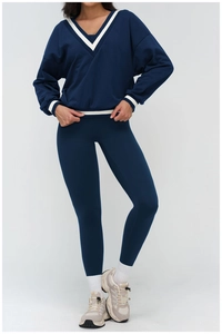 Full view of women's navy V-neck striped sweatshirt and matching leggings set