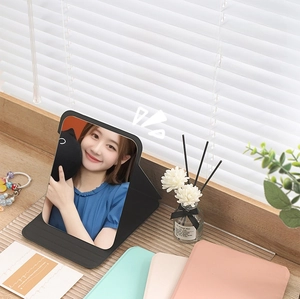 Foldable HD vanity mirror with PU leather cover showing multiple color options for desktop