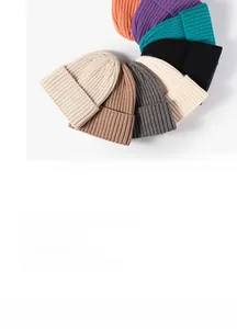 Flat lay of ribbed knit beanies showing various colors like orange, purple and grey