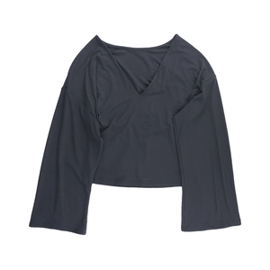 Detail view of charcoal grey V-neck slim-fit cropped top with long flared sleeves