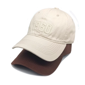 Close-up of 1950 3D embroidered baseball caps in beige and brown cotton twill