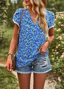 Detail of blue V-neck T-shirt showing short sleeves with elegant white lace trim accents