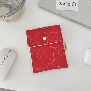 Red quilted sanitary napkin pouch with white bunny patterns and snap button closure