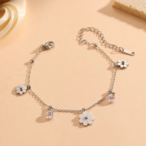 Elegant titanium steel daisy bracelet with white enamel flowers and crystal accents