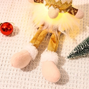 Detail of a glowing Christmas gnome with golden sequins and soft faux fur texture