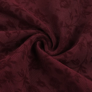 Close-up of wine red jacquard mesh fabric featuring intricate floral patterns and texture