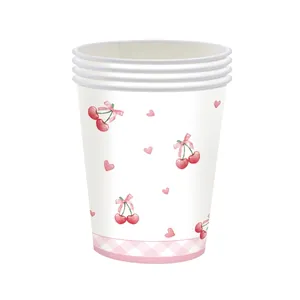 Close-up of disposable paper cups with cherry and pink bow patterns for party decor