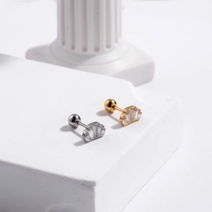 Detailed macro view of crown shaped stainless steel cartilage studs with cubic zirconia