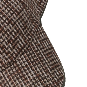 Close-up of brown houndstooth wool fabric texture on a vintage style baseball cap