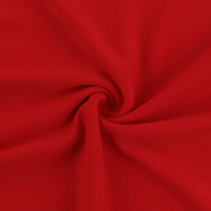 Gros plan sur la texture du tissu rouge tricoté avec pli en spirale et fini soyeux