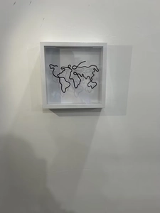 Minimalist white deep frame with black metal wire world map sculpture on white background