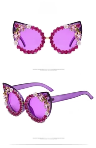 Detail of cat-eye sunglasses with purple lenses and floral rhinestone embellishments
