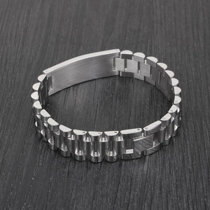 Macro detail of silver presidential style bracelet with a smooth blank curved metal plate