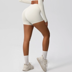 Detail shot of high-waisted yoga shorts in cream white with butt-lifting seam design
