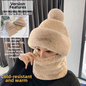 Detail of beige knit winter hood with thick faux fur lining and large pom-pom accent