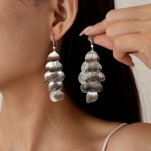 Silver hollow leaf tassel drop earrings featuring a retro metallic multi-petal design