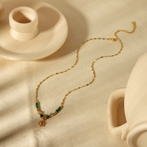 Bohemian 18k gold plated sun goddess pendant necklace with mixed green beads on linen