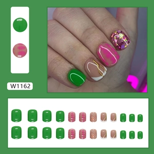 Short round press-on nails set featuring green polish, pink dots and gold foil W1162