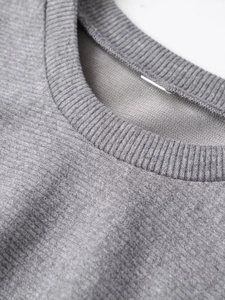 Macro view of gray round neckline with premium ribbed knit texture and soft fabric detail