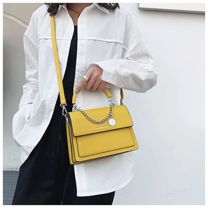 Detail of yellow leather flap handbag featuring silver chain and Fashion & Bags text