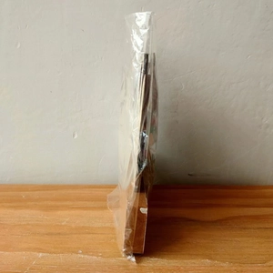 Detailed side view of a 3D wooden Christmas gnome ornament in clear plastic packaging