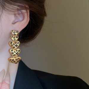Detailansicht langer herzförmiger Leopard-Ohrringe mit Goldfinish und Kristallen
