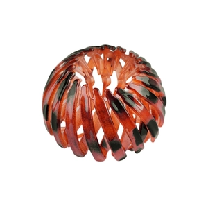 Detail of amber tortoiseshell bird nest hair claw clip with expandable resin teeth design