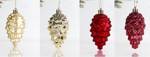 Detailed view of matte and shiny pine cone ornaments in gold and red colors