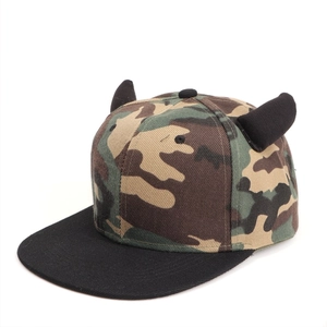 Detail of a jungle camouflage snapback cap with black 3D devil horns in street style
