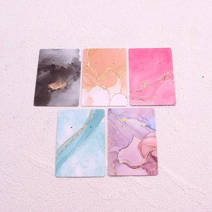 Set of five marble pattern jewelry display cards for earrings and necklaces with pre-cut holes