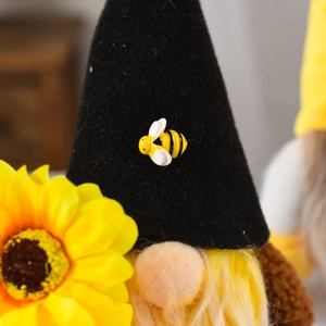 Macro shot of bee gnome plush with felt sunflower and long golden faux fur beard detail