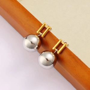 Detail of two-tone geometric earring with gold rectangular clasp and silver ball drop
