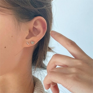 925 sterling silver bear stud earrings with gold plating and zircons on model ear